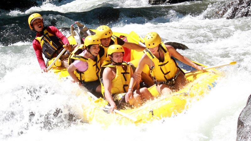 Rafting team tackling the intense Class 4 rapids of Bali's vibrant rivers