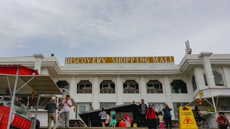 Entrance of Discovery Shopping Mall in Kuta, Bali with visitors milling about