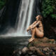 Visitors enjoying a swim in the natural pool at Munduk Waterfall