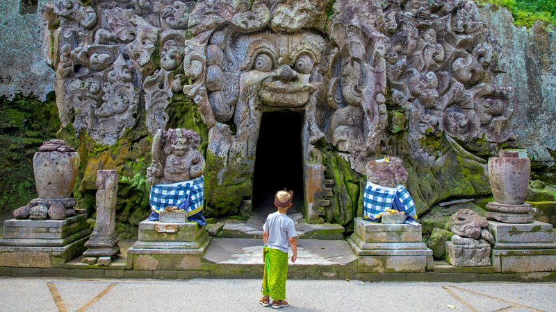 Young traveler exploring Goa Gajah, an affordable temple in Ubud, Bali.