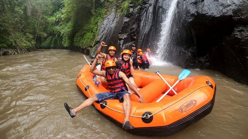 Joyful rafters by a waterfall on Ayung River Ubud