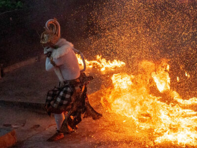 Traditional Kecak Fire Dance performer in action at Uluwatu Temple, Bali