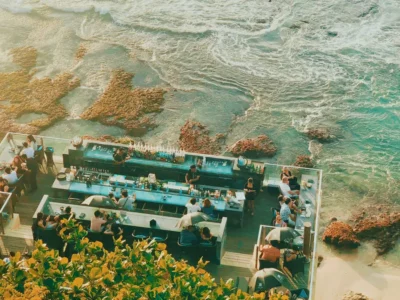 Aerial view of beach bar with blue sea background in Jimbaran