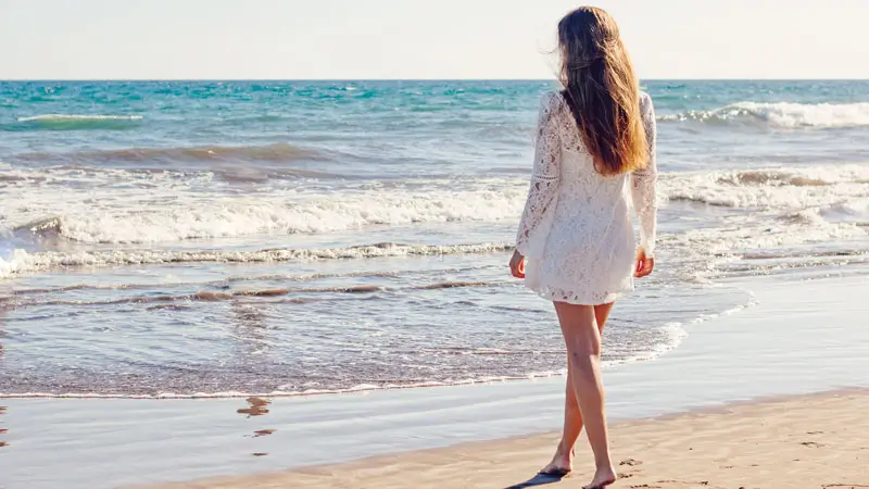 Daytime atmosphere with female tourists walking on the beach, holiday itinerary activities in Jimbaran.