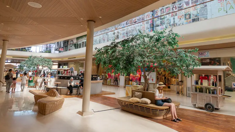 Interior view of Seminyak Village Mall, showcasing stylish seating areas and shoppers, highlighting it as one of the top 10 best shopping spots in Bali.