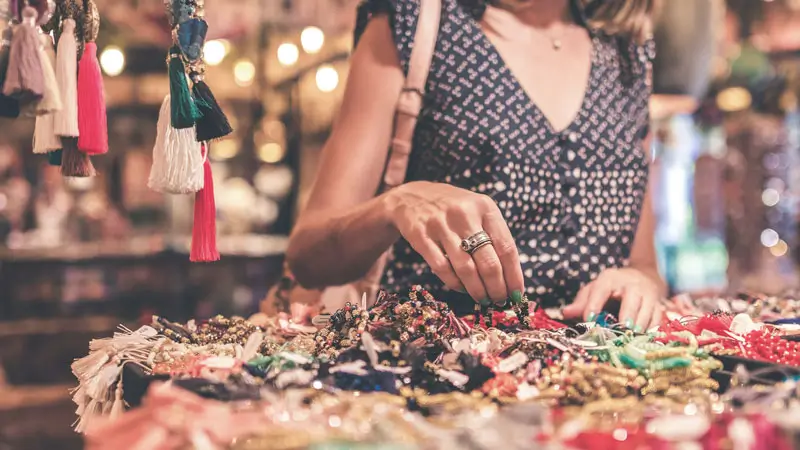 A tourist shopping for colorful jewelry at Sukawati Art Market in Gianyar