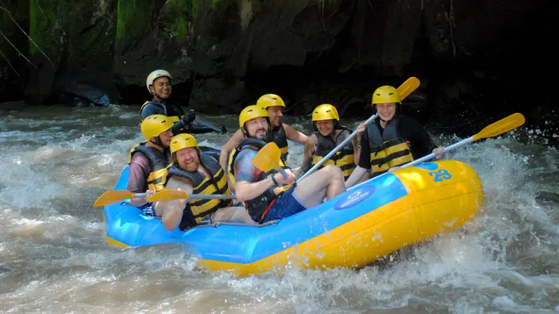 Group enjoying a fun rafting experience on the gentle rapids of Ubud river