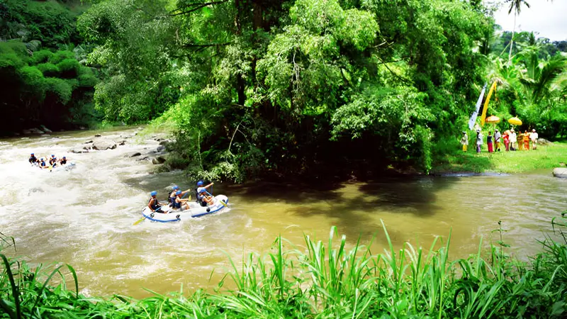 Scenic view of Ayung River rafting in Ubud, surrounded by lush green jungle.