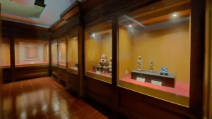 Traditional Balinese sculptures and artifacts on display in a museum gallery in Bali.