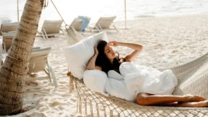 Woman relaxing on a hammock by the beach - Bali itinerary beach vacation plan