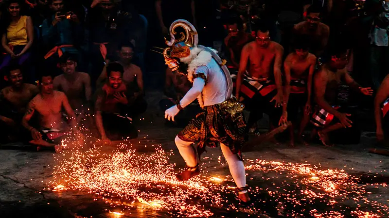 Hanoman character in Kecak Dance performing a fire ritual at Uluwatu Temple.