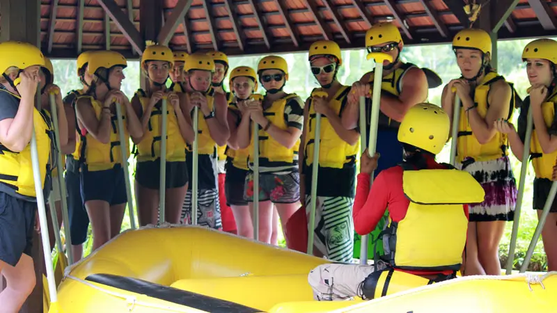 Beginner rafters receiving a safety briefing before their Karangasem Whitewater Rafting, equipped with helmets and life jackets.