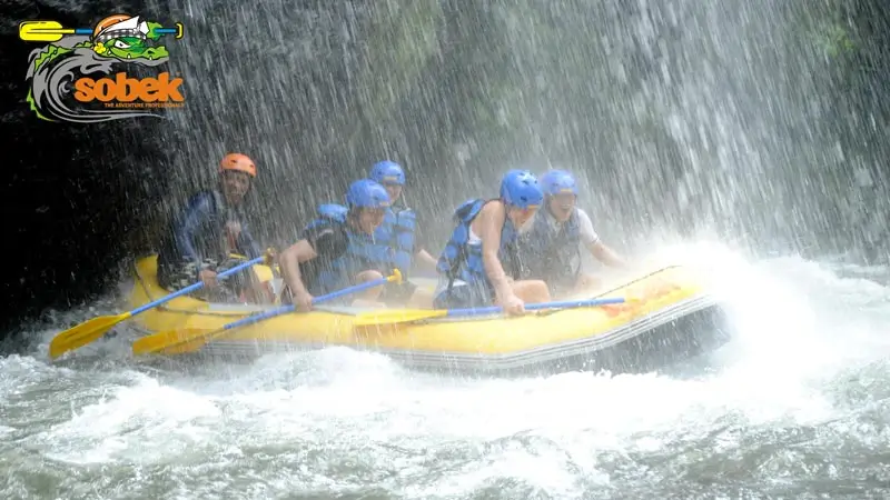 Sobek Rafting team navigating through powerful rapids on Telaga Waja River in Bali, ensuring a premium and safe whitewater experience.