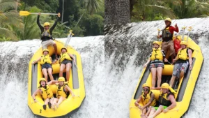 Excited tourists rafting down a 5-meter waterfall drop at Telaga Waja River in Bali, experiencing an adrenaline-pumping whitewater adventure.