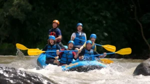 Exciting whitewater rafting adventure on the Ayung River in Bali, featuring a group of tourists navigating rapids with joy and enthusiasm.