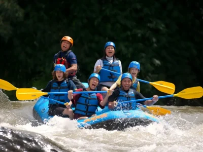 Exciting whitewater rafting adventure on the Ayung River in Bali, featuring a group of tourists navigating rapids with joy and enthusiasm.