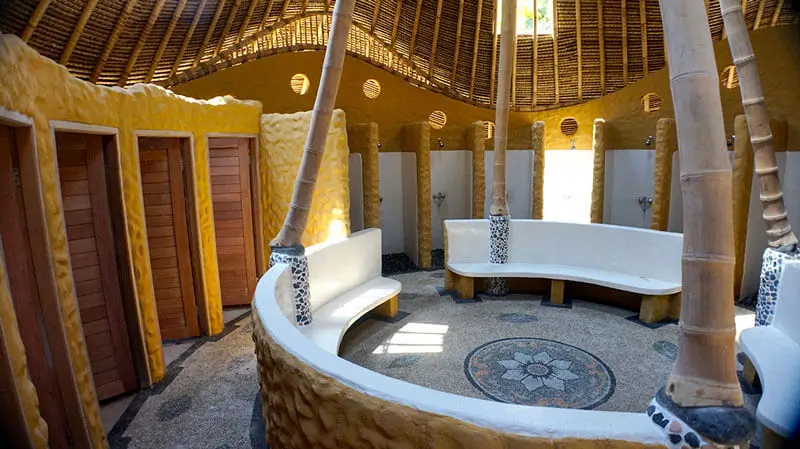 Spacious and eco-friendly shower and changing rooms at a Sobek facility, featuring bamboo architecture and modern amenities.